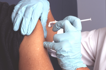 A vaccine being administered into an arm