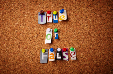 Cut out letters of various colors and fonts pinned on a cork board reading "True or False"