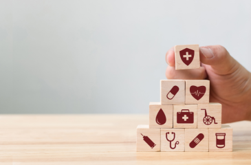 Stacks of blocks with icons related to healthcare on them