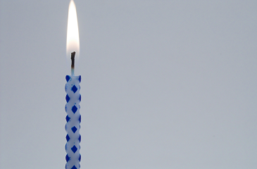 A single lit birthday candle