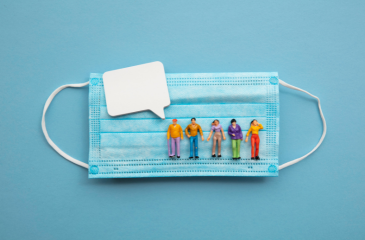 A blue surgical mask with 5 figurines in a line and an empty quote box. 
