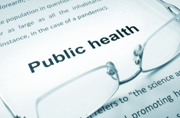 a document reads public health with glasses laying on top