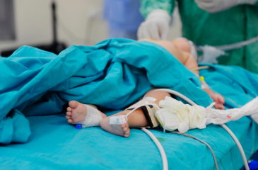 Pediatric patient on a hospital bed in the ICU